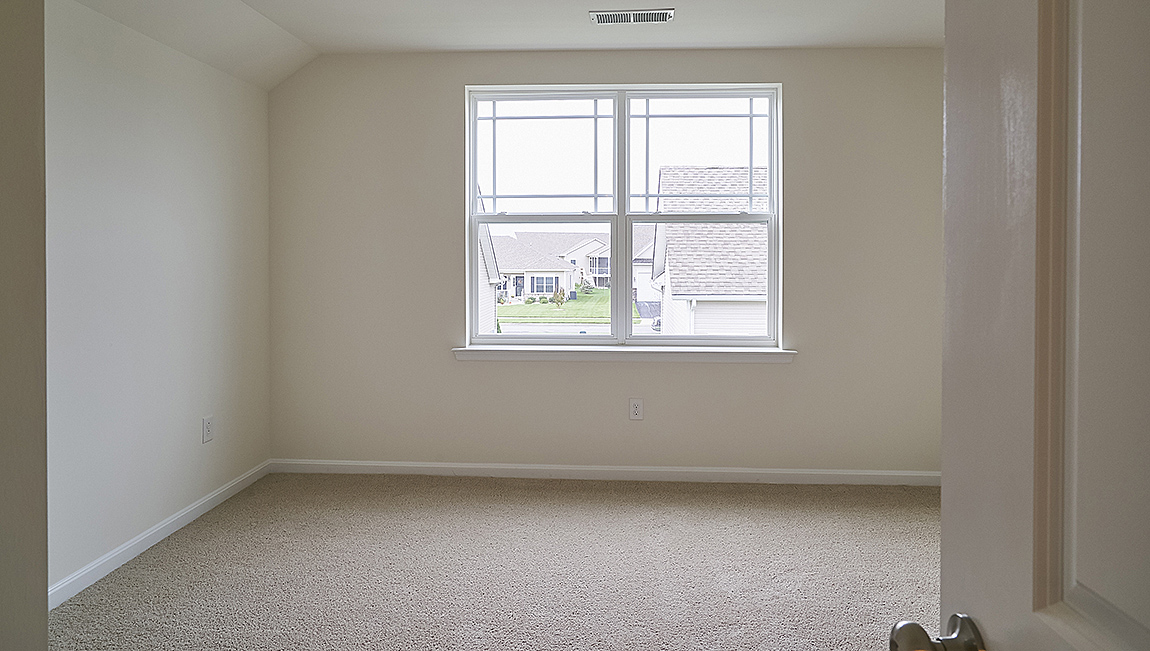 The guest bedrooms and the secondary bathroom are located near the front of the home.