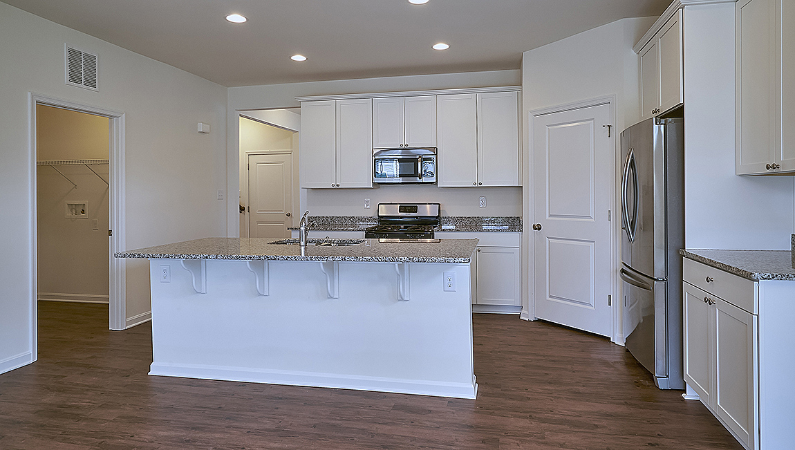 The well-designed kitchen boasts plenty of cabinets.