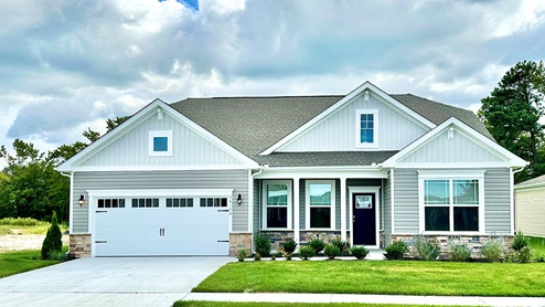 Coastal Villages Galveston home with tan siding.