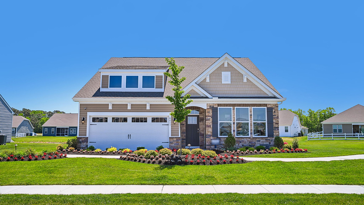 Coastal Villages Azalea home with a stone front.