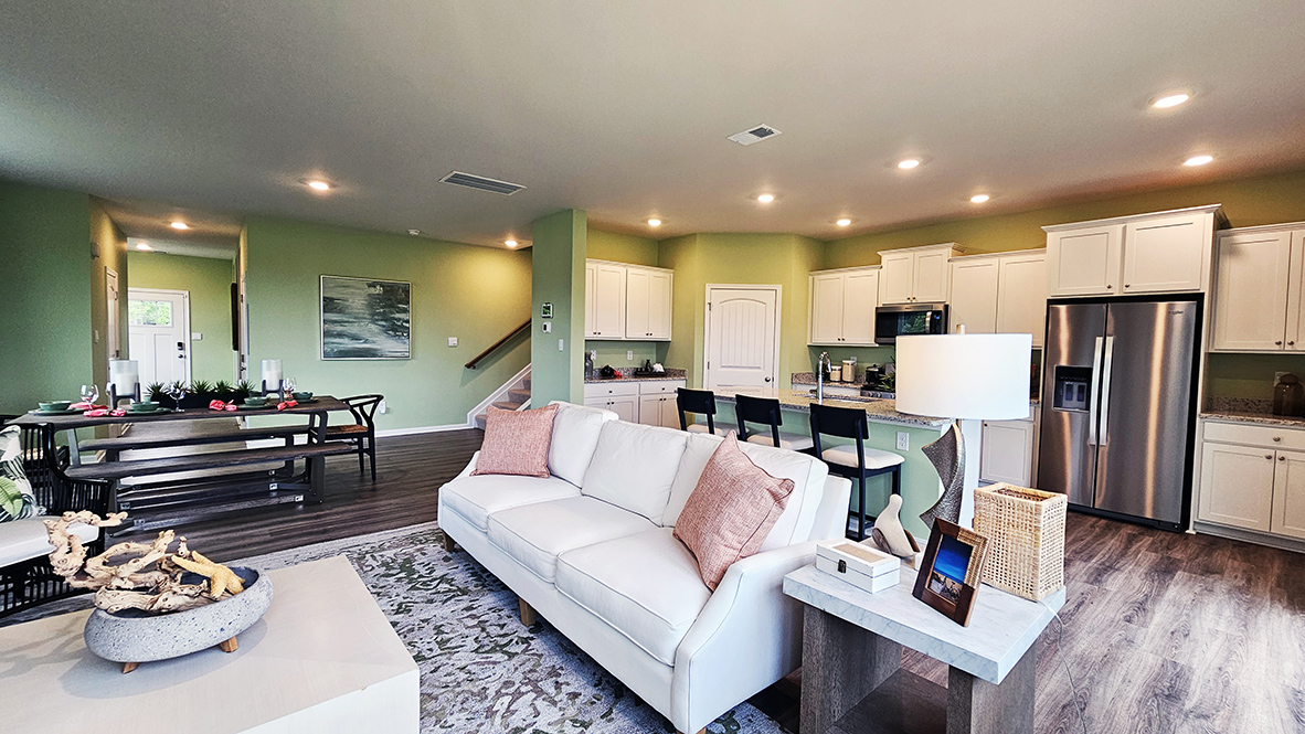 The dining area, centered kitchen, and expansive great room are all open and allow for family and friends to gather comfortably.