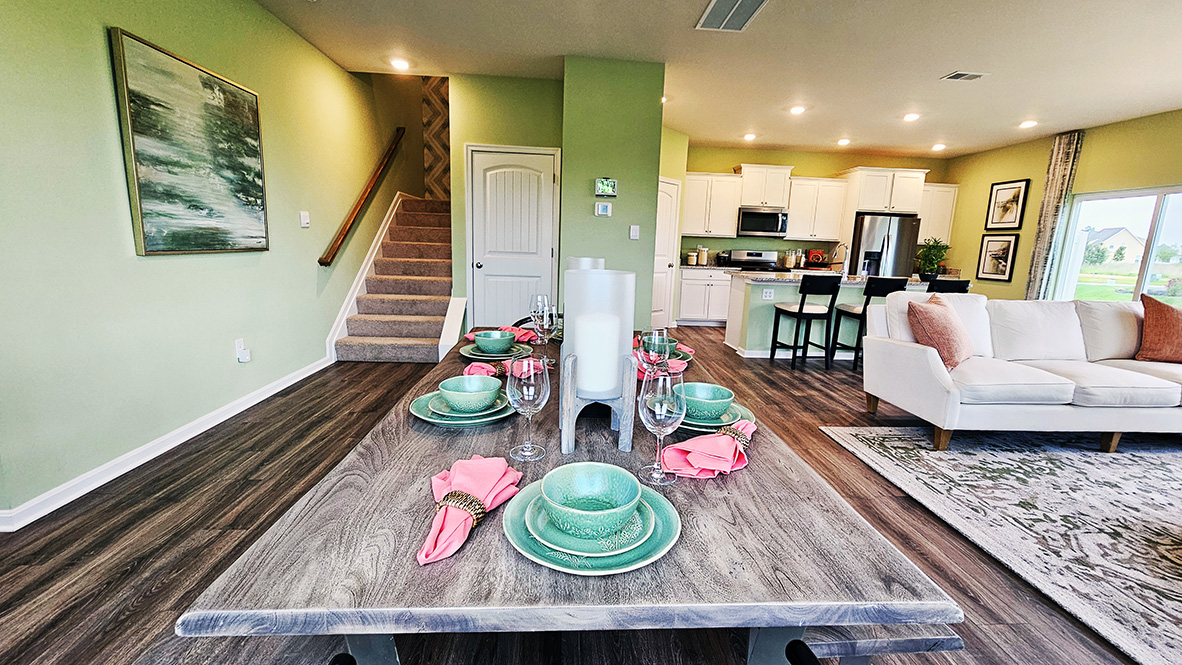 The dining area, centered kitchen, and expansive great room are all open and allow for family and friends to gather comfortably.