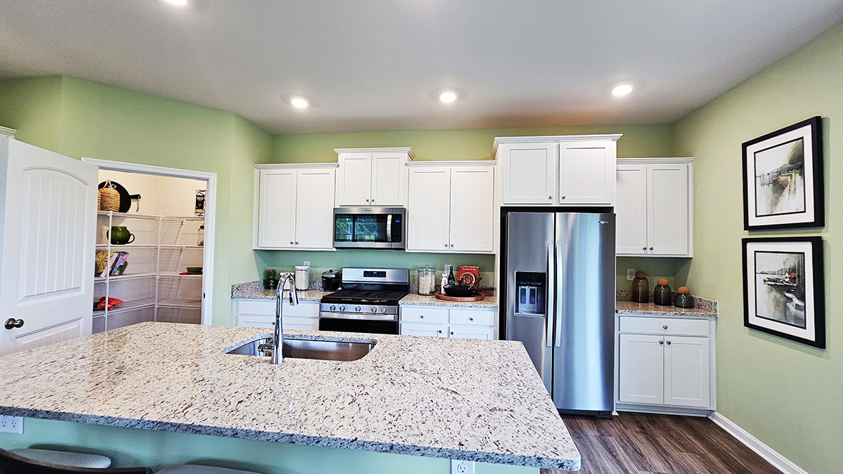 The home's well-appointed kitchen boasts stainless steel appliances.