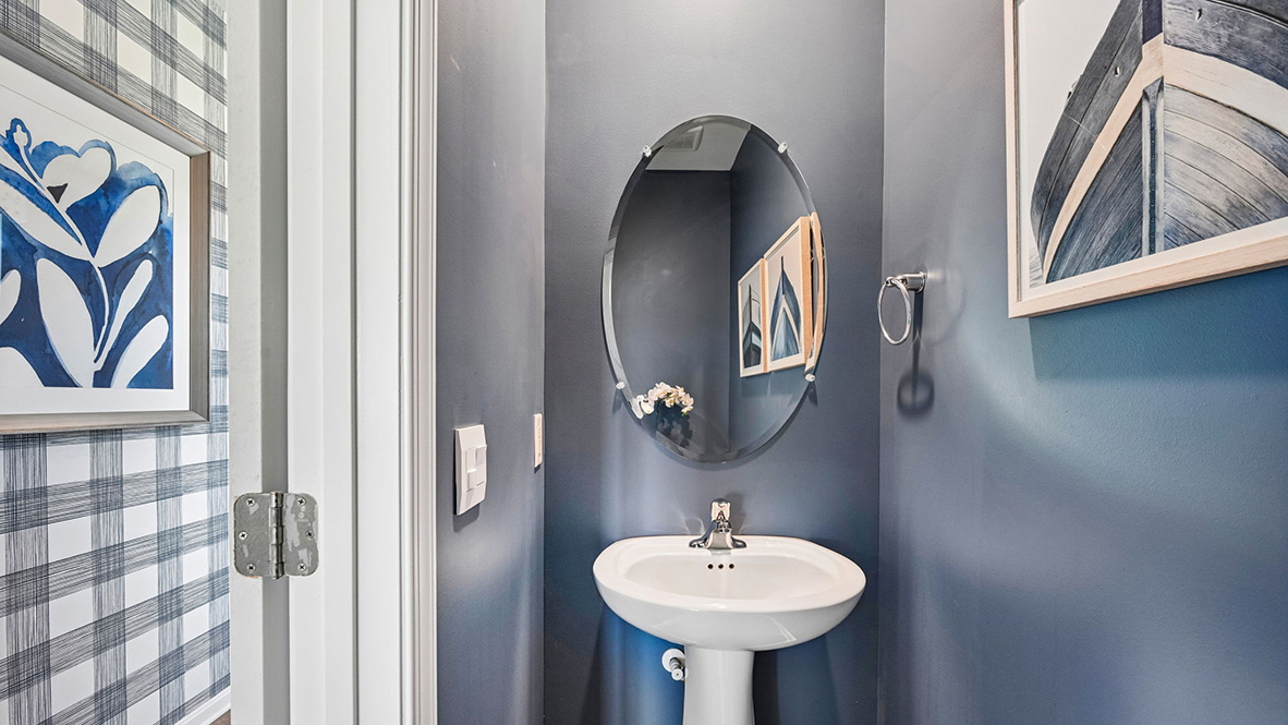 The inviting foyer offers a convenient powder room.