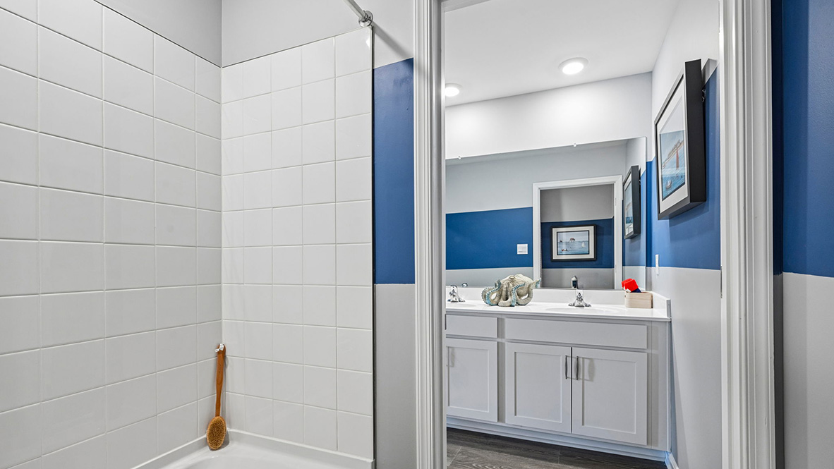 The modern guest bathroom has a double vanity and generously sized shower.