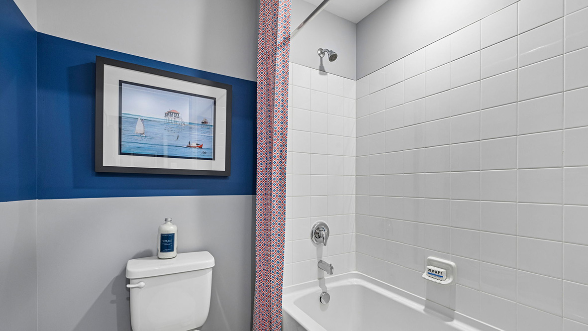 The modern guest bathroom has a double vanity and generously sized shower.