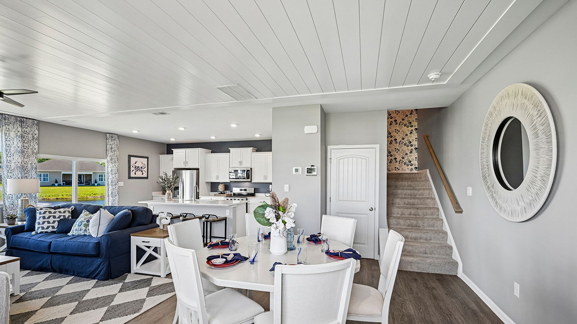 The dining area, centered kitchen, and expansive great room are all open and allow for family and friends to gather comfortably.