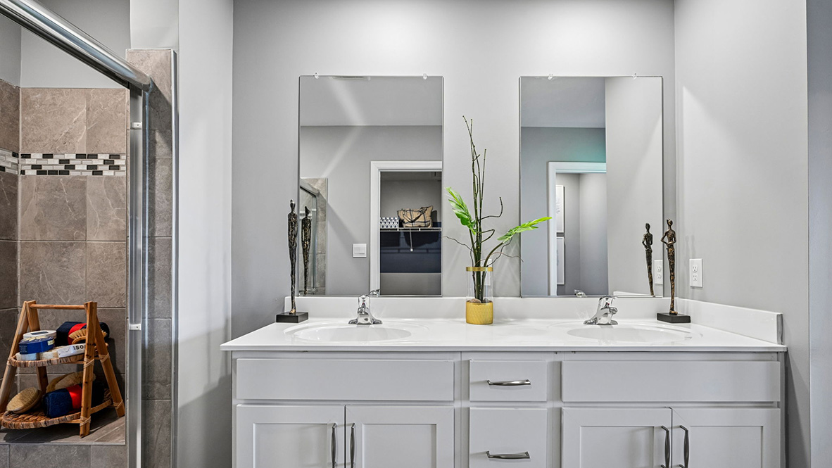 The modern primary bathroom has a double vanity and generously sized shower.