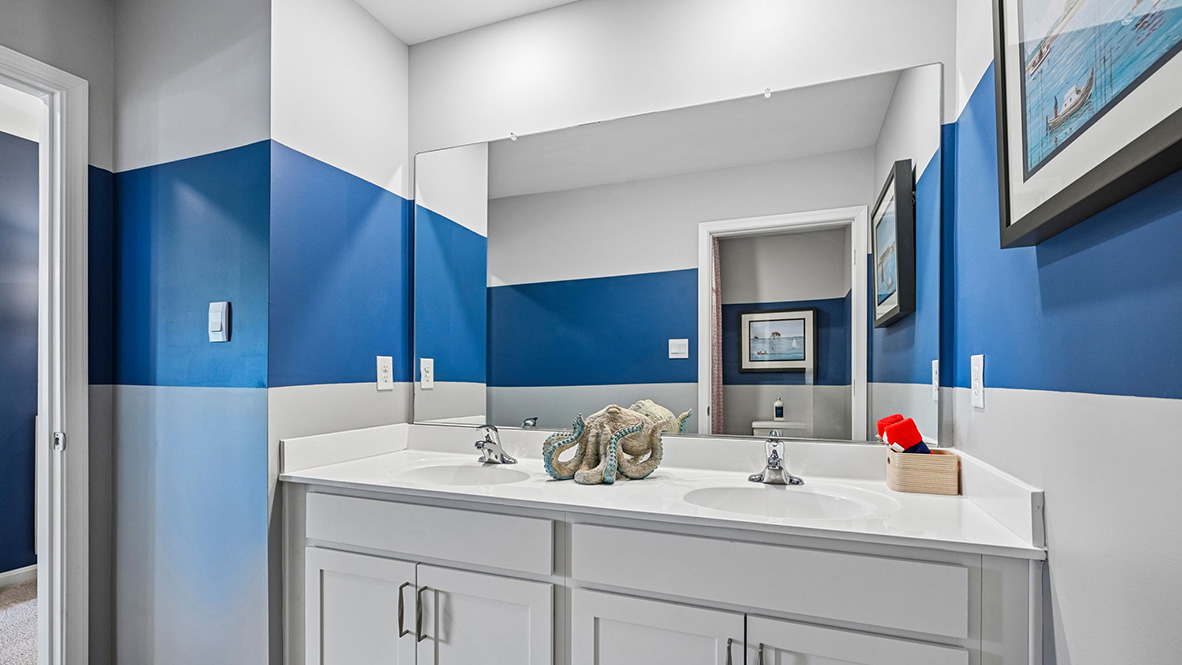 The modern guest bathroom has a double vanity and generously sized shower.