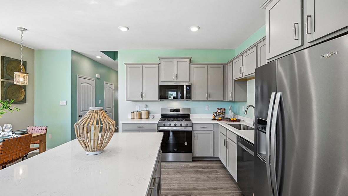 The home’s well-designed eat-in kitchen boasts stainless steel appliances.