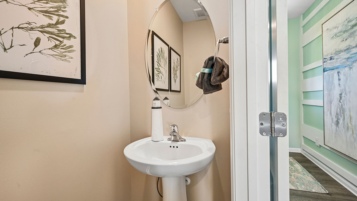 The inviting foyer features the conveniently located powder room.