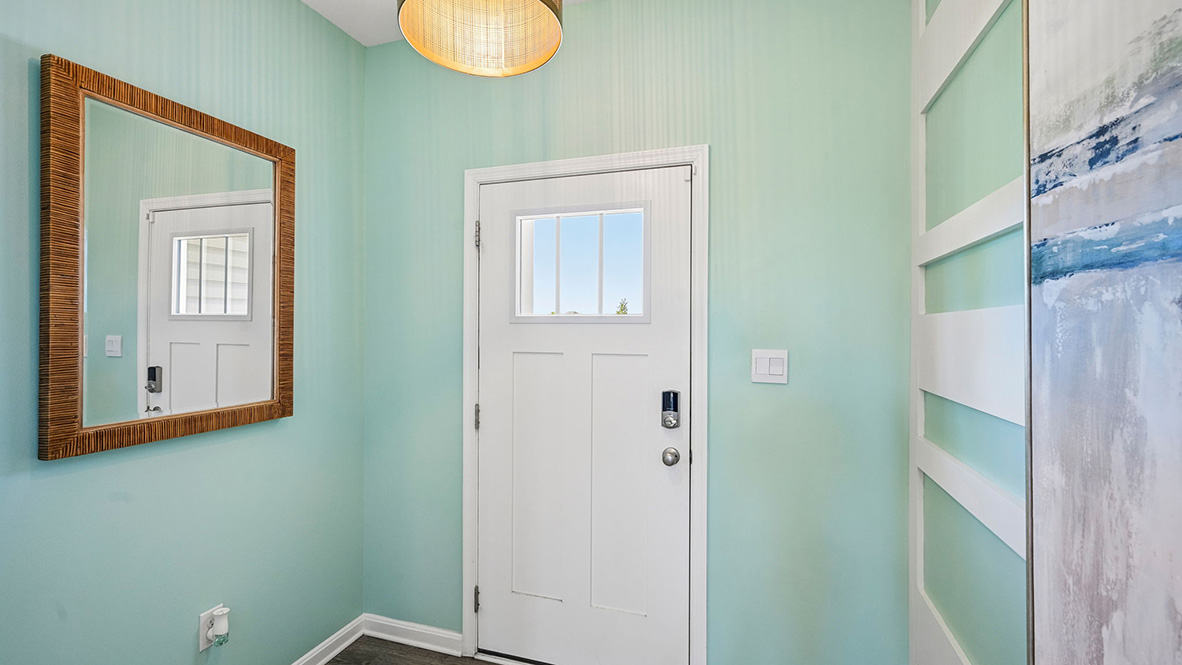 The inviting foyer features a coat closet and access to the conveniently located powder room.