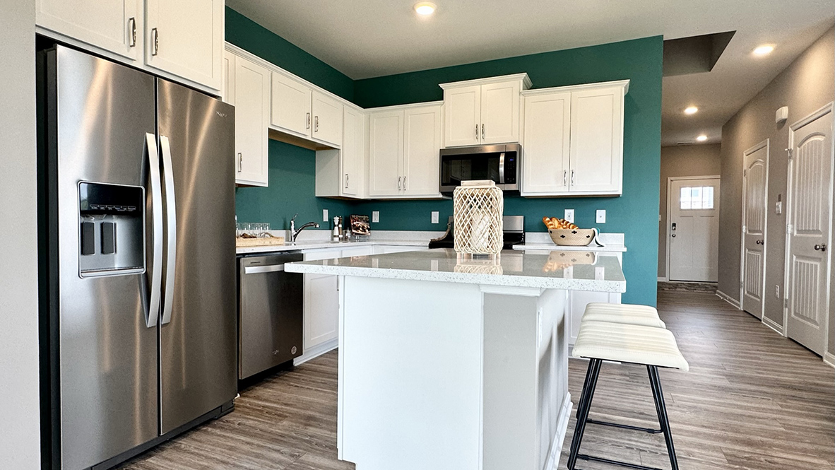 The home’s well-designed eat-in kitchen boasts substantial cabinet space.