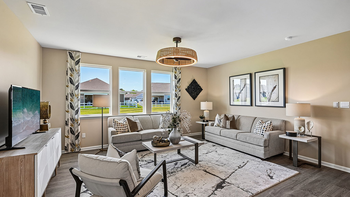 Featuring plank flooring, the kitchen is open to the living room.