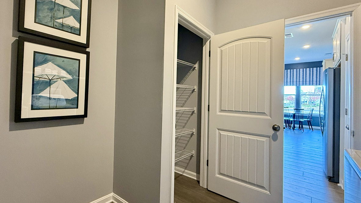 The large laundry room, tucked between the kitchen and the two-car garage, also features an additional coat closet.