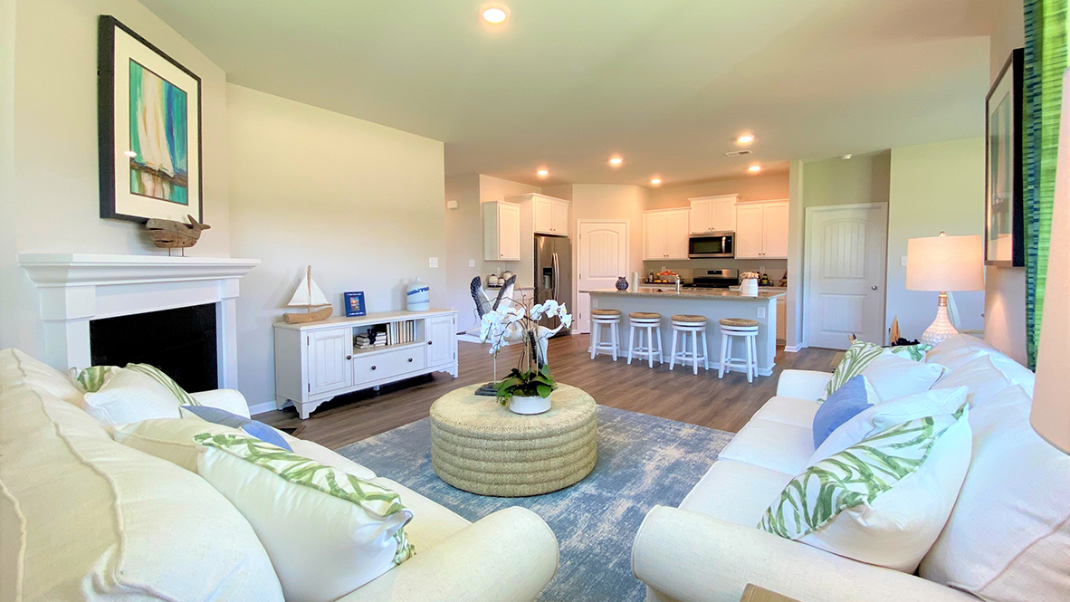 The living area opens into the kitchen and dining rooms.