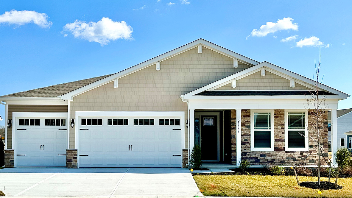A one-story Wheaton home with tan siding and a front porch.