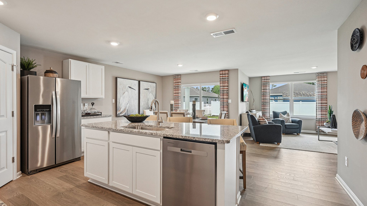 The kitchen includes a large center island with a sink.