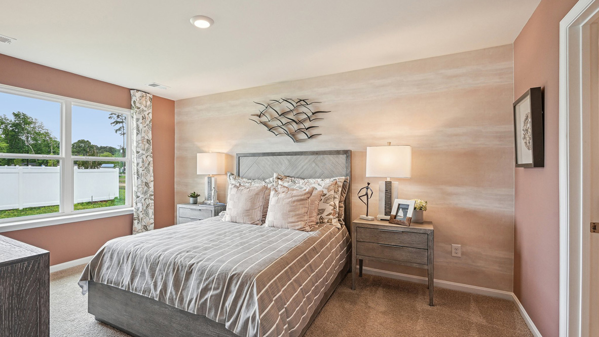 The primary bedroom has a large double window.