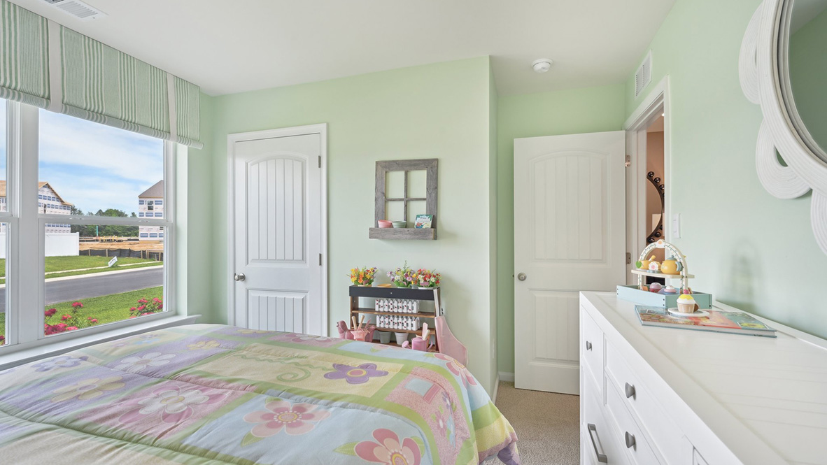 This guest bedroom has a corner closet.