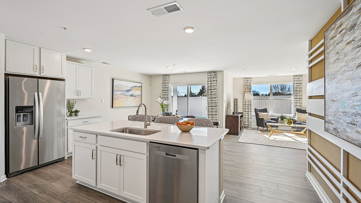 The kitchen is open to the informal dining area that leads to the back sliding door.