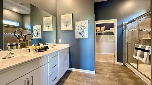 The private owner’s suite is a retreat in the back of the home with a spacious bathroom with a luxury shower.