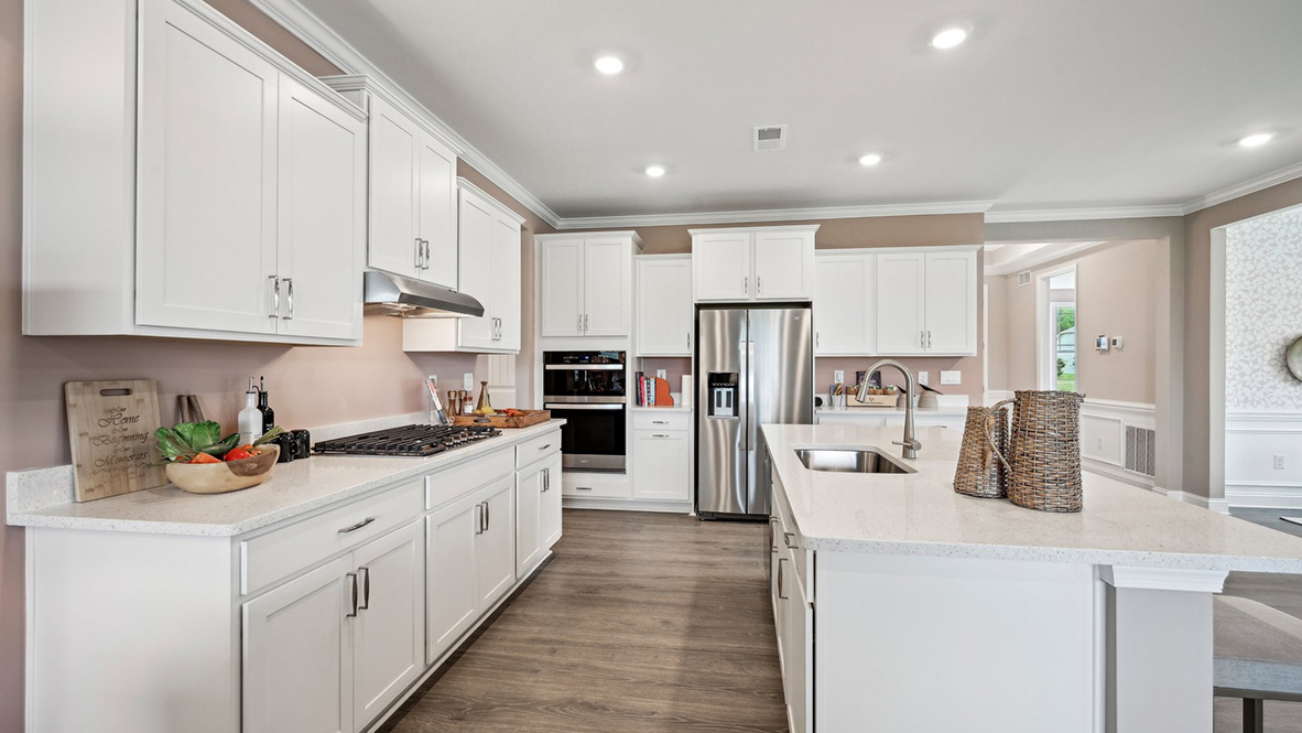 The kitchen has an oversized island with quartz countertops.