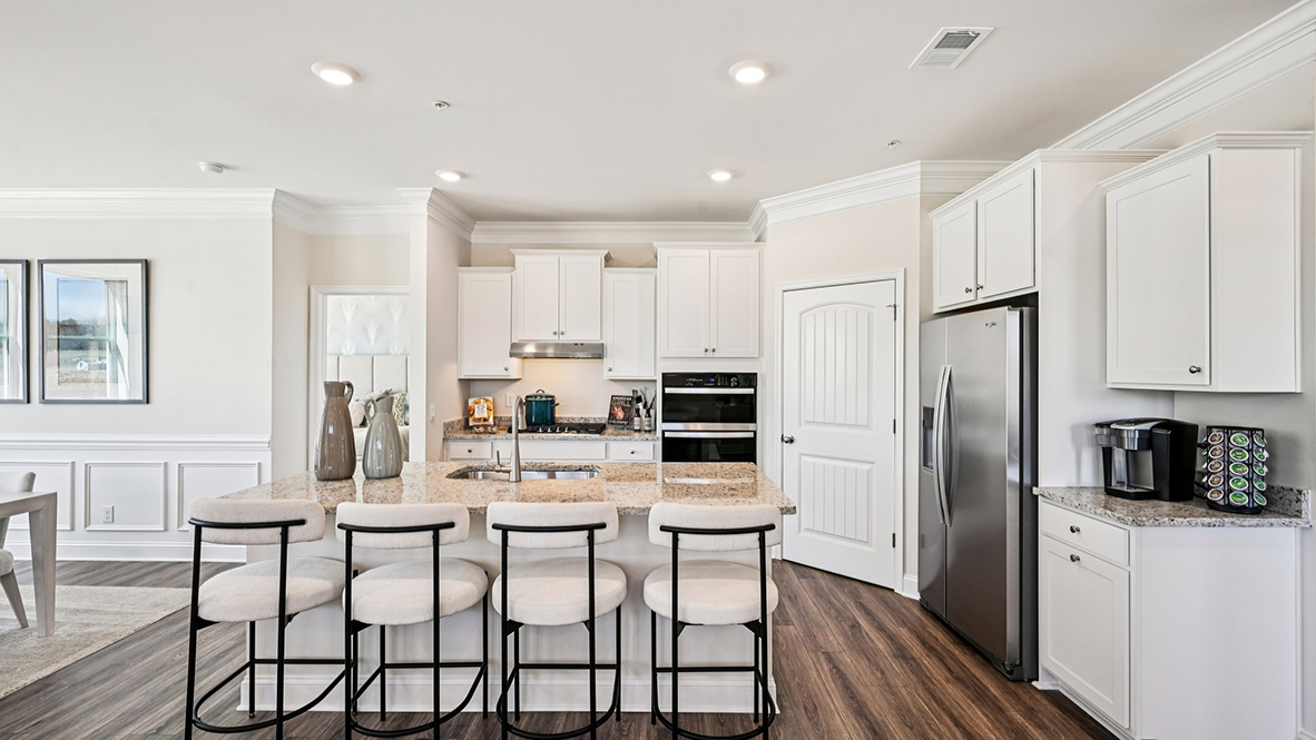 The kitchen offers a corner pantry.