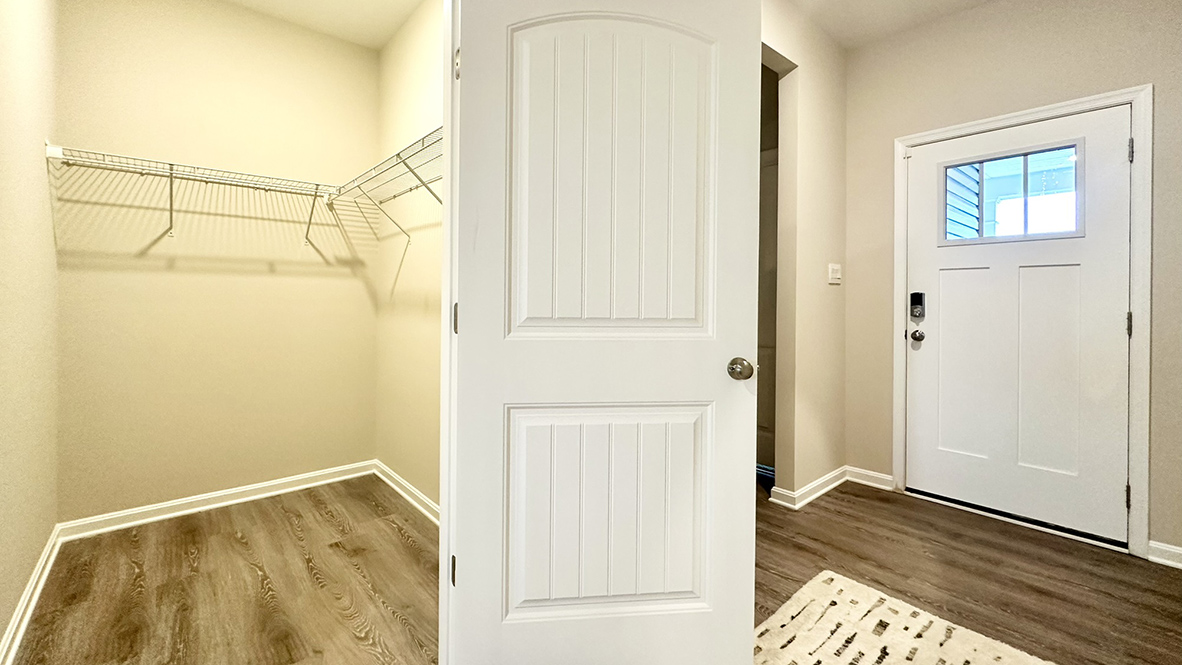 A welcoming foyer has a large coat closet.
