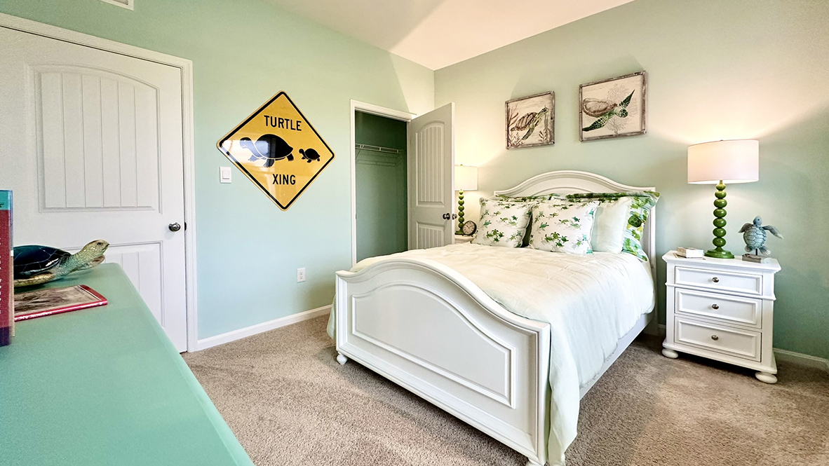 The spacious guest bedroom has a closet.