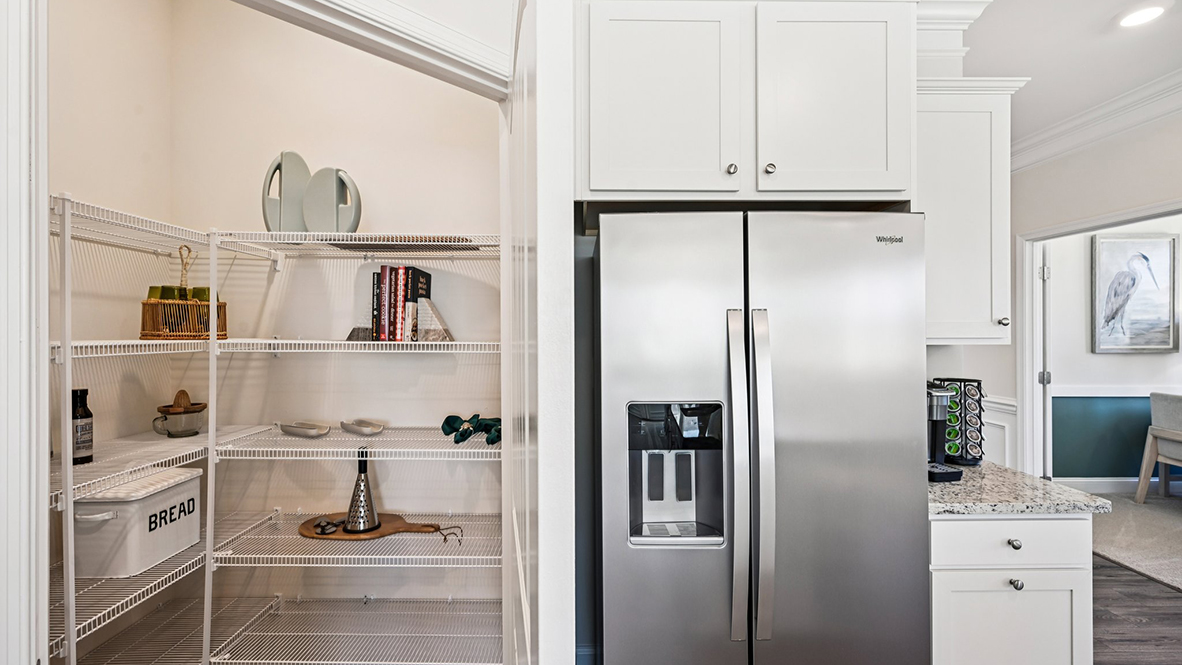 The kitchen offers a corner pantry and stainless steel appliances.