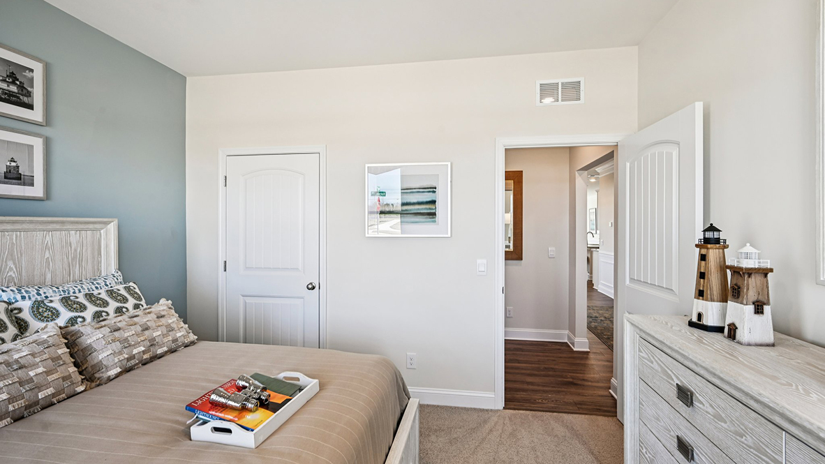 The spacious guest bedroom has a closet.