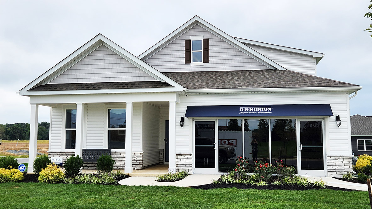 Gannon Range Bristol model home with white siding and white stone.