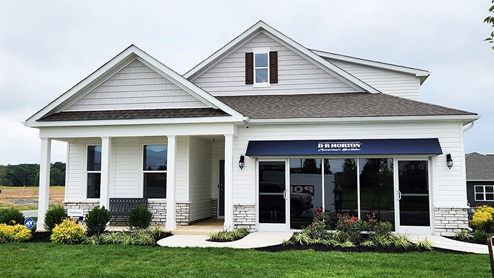 Gannon Range Bristol model home with white siding and white stone.