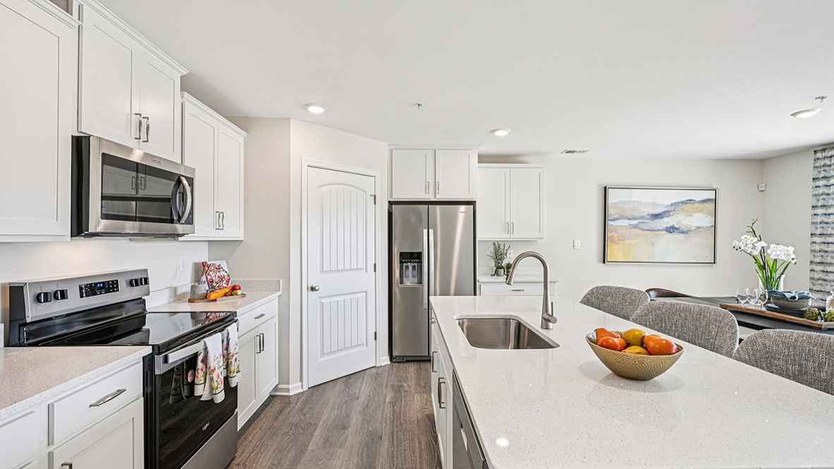 The kitchen includes stainless steel appliances.