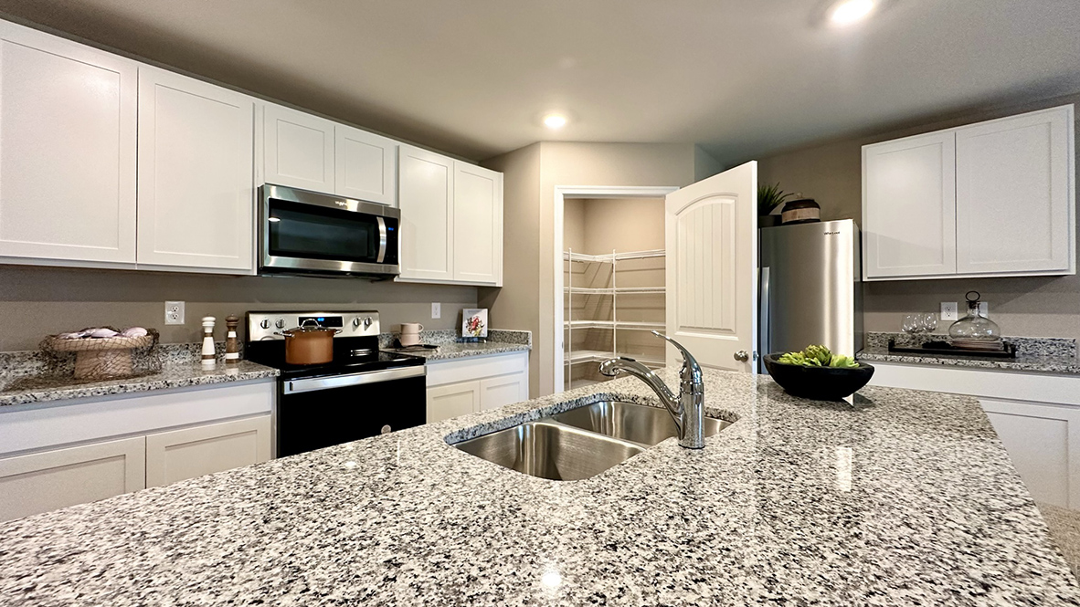 A sizable pantry closet is in the corner of the room.