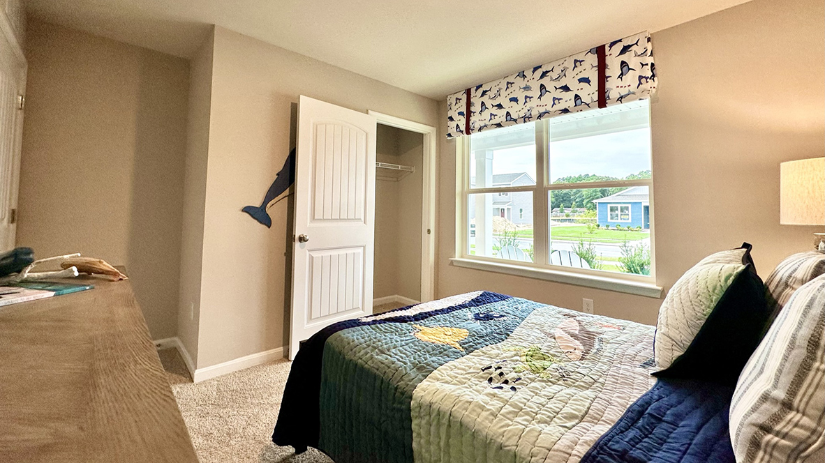 The second guest bedroom has a closet in the corner of the room.