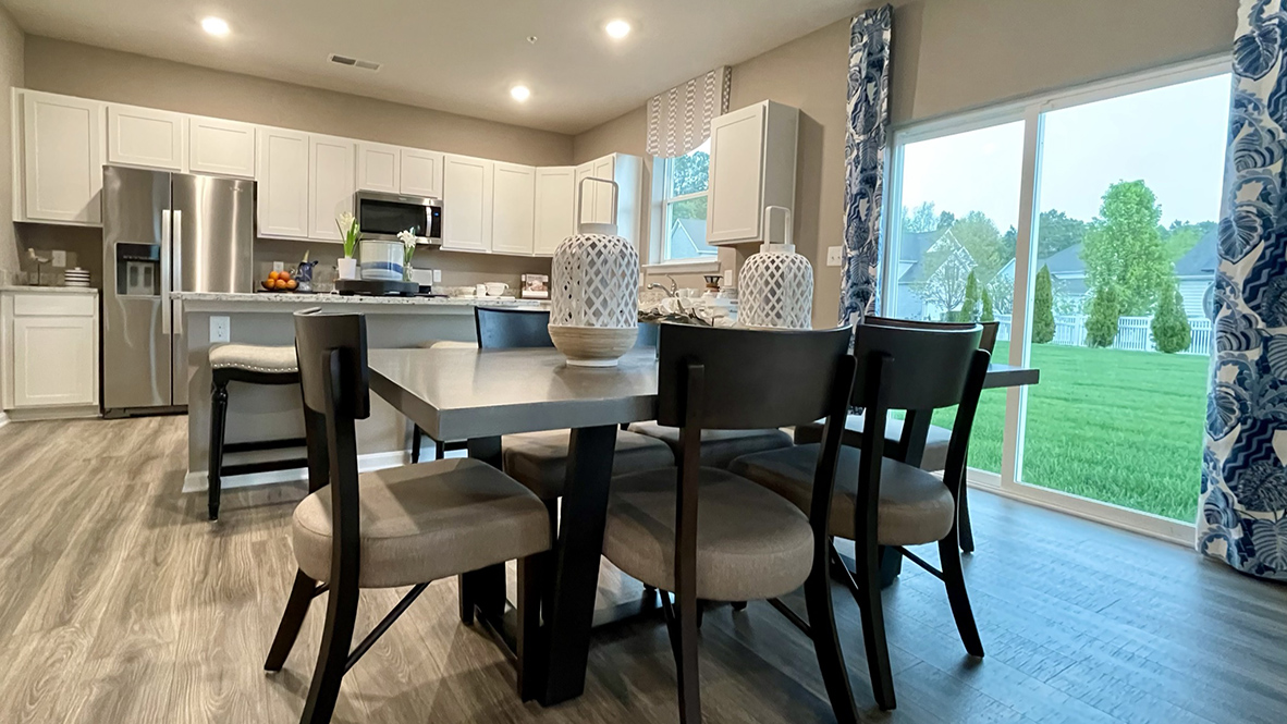 The dining area leads to a sliding glass door.