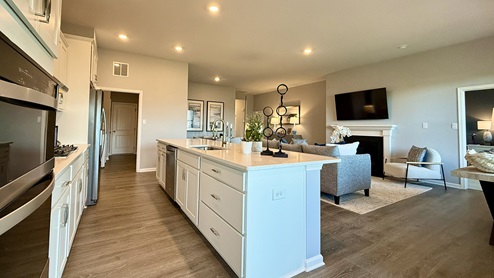 The open floorplan features a well-designed kitchen complete with beautiful countertops.