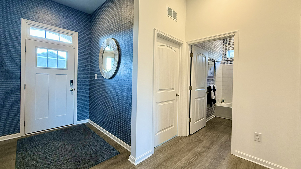 The welcoming foyer separates to afford privacy to the secondary bathroom.
