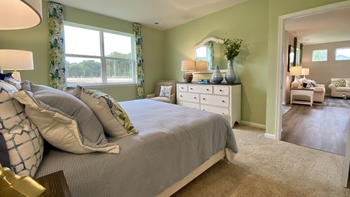 The large primary bedroom is a retreat in the back of the home.
