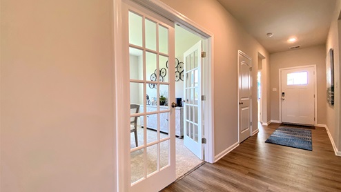 Stylish French doors open into the flex room.