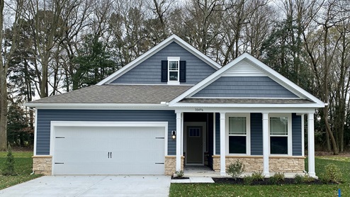 Millville by the Sea Bristol home with pebble clay siding and tuxedo gray shutters.