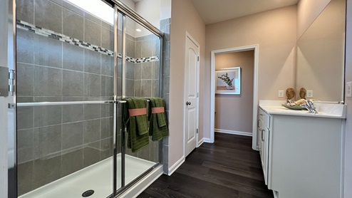 The primary bathroom has a large walk-in shower.