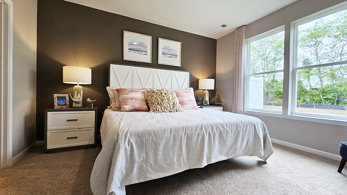 The private main suite is tucked in the back of the home and includes a large en suite bathroom.