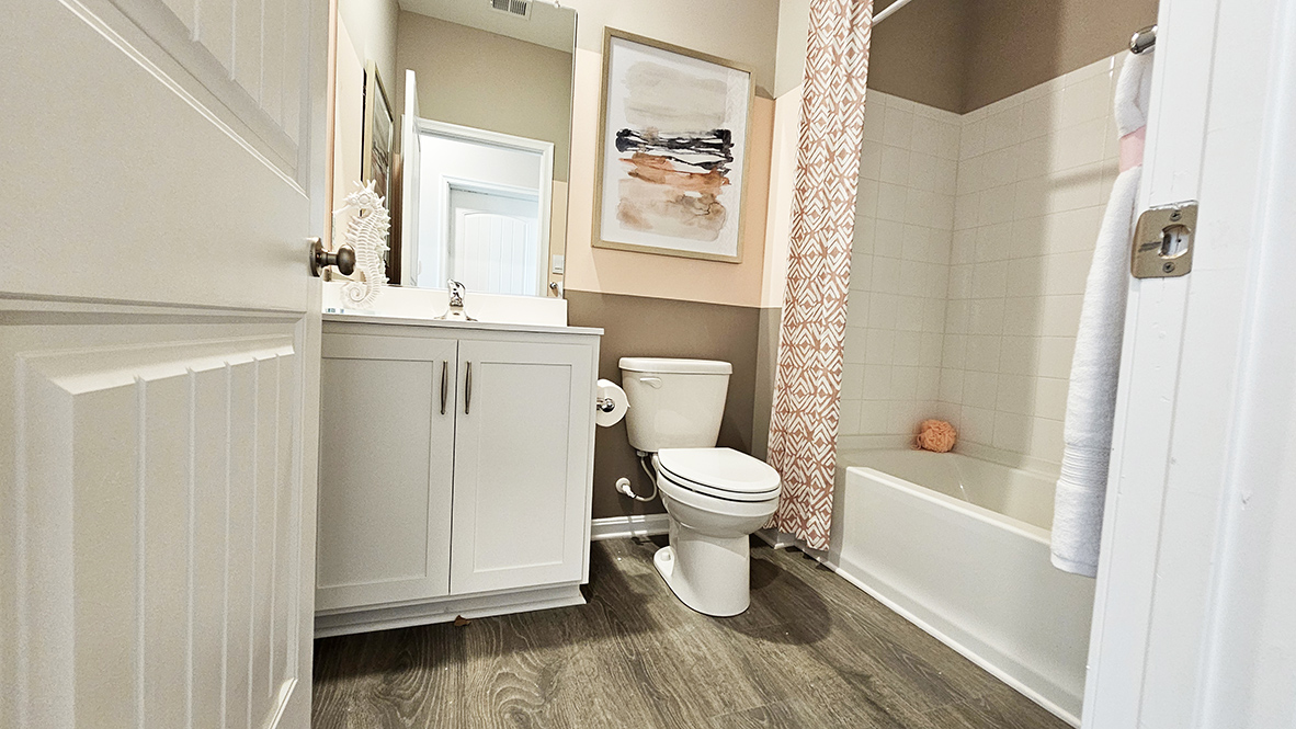 Continuing down the hall is another guest bedroom and a full bathroom.