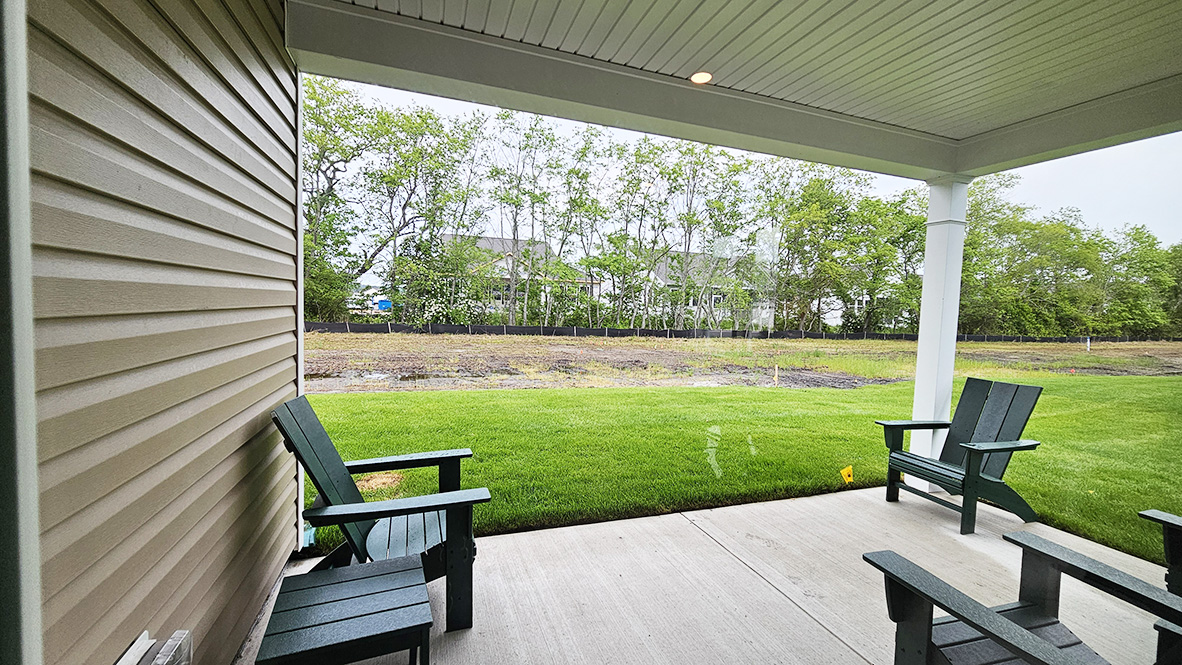 The great room provides access to the quiet covered porch at the rear of the home.