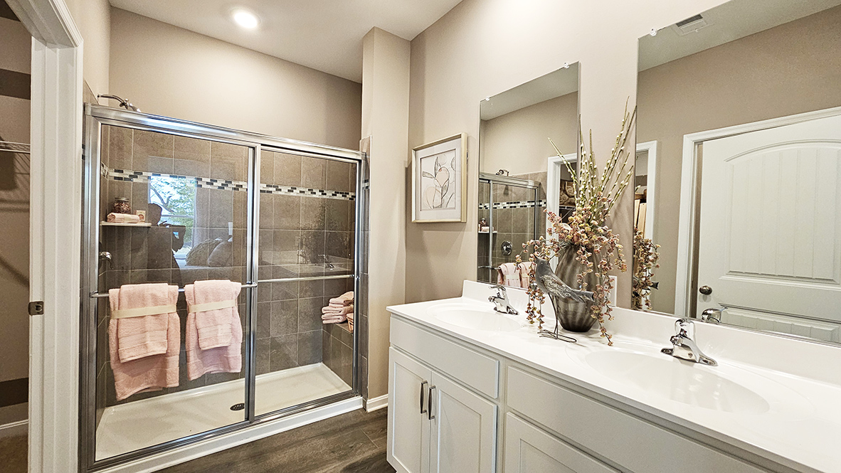 The private main suite is tucked in the back of the home and includes a large en suite bathroom.