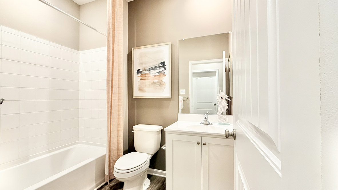 Continuing down the hall is a full bathroom.