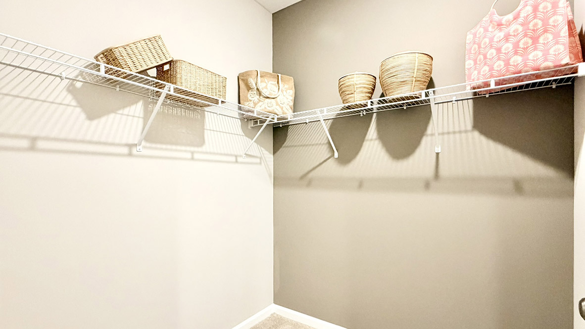 The private main suite is tucked in the back of the home and includes a large walk-in closet.